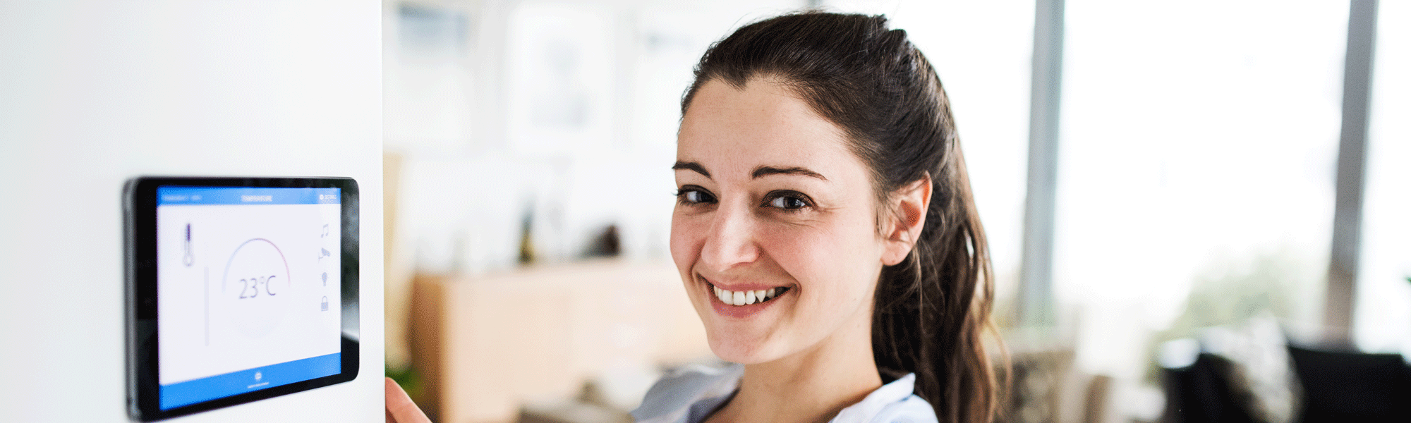 Woman Checking The Thermostat